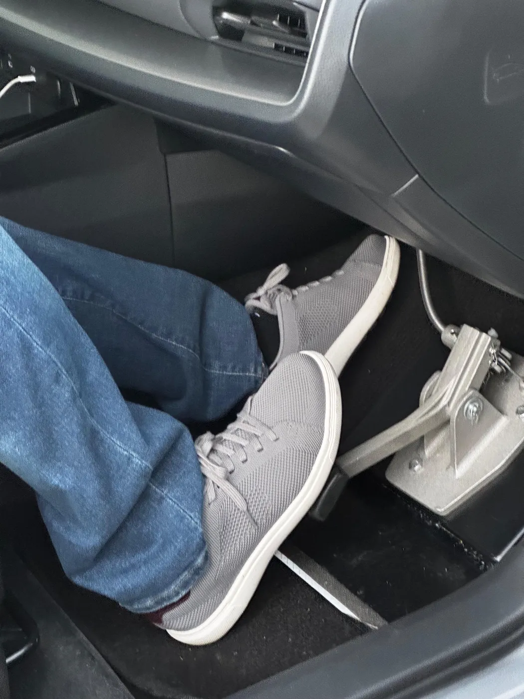 Passenger-side dual-control brake pedal inside a lesson car